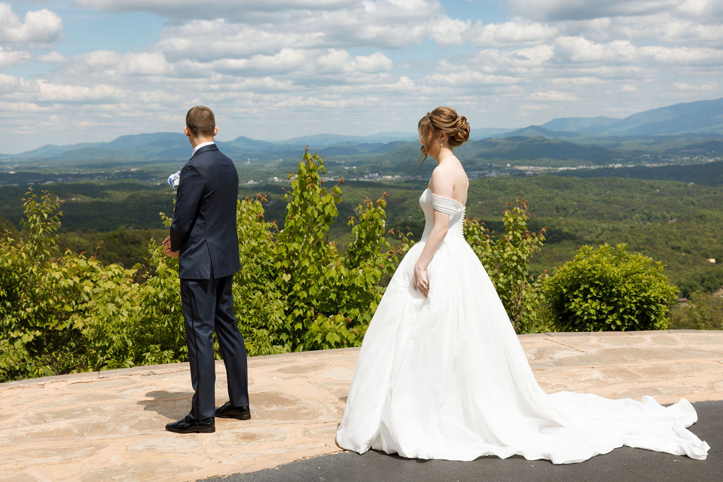 Bride waiting during a first look moment with sweeping mountain views at a Smoky Mountain wedding venue
