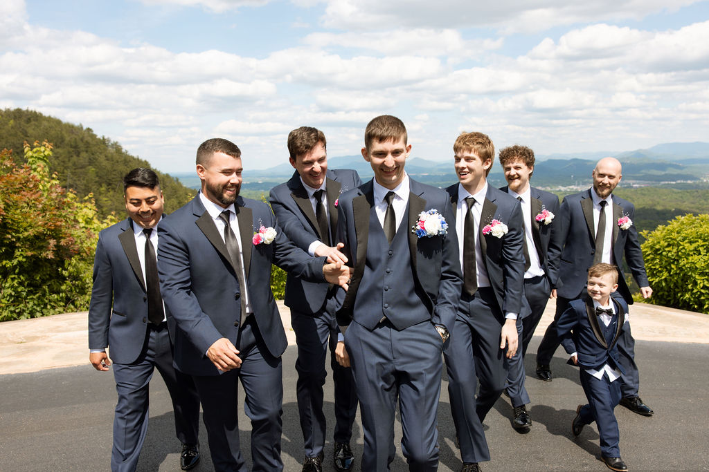 Groom and groomsmen walking together outdoors before the ceremony at a Sevierville wedding venue