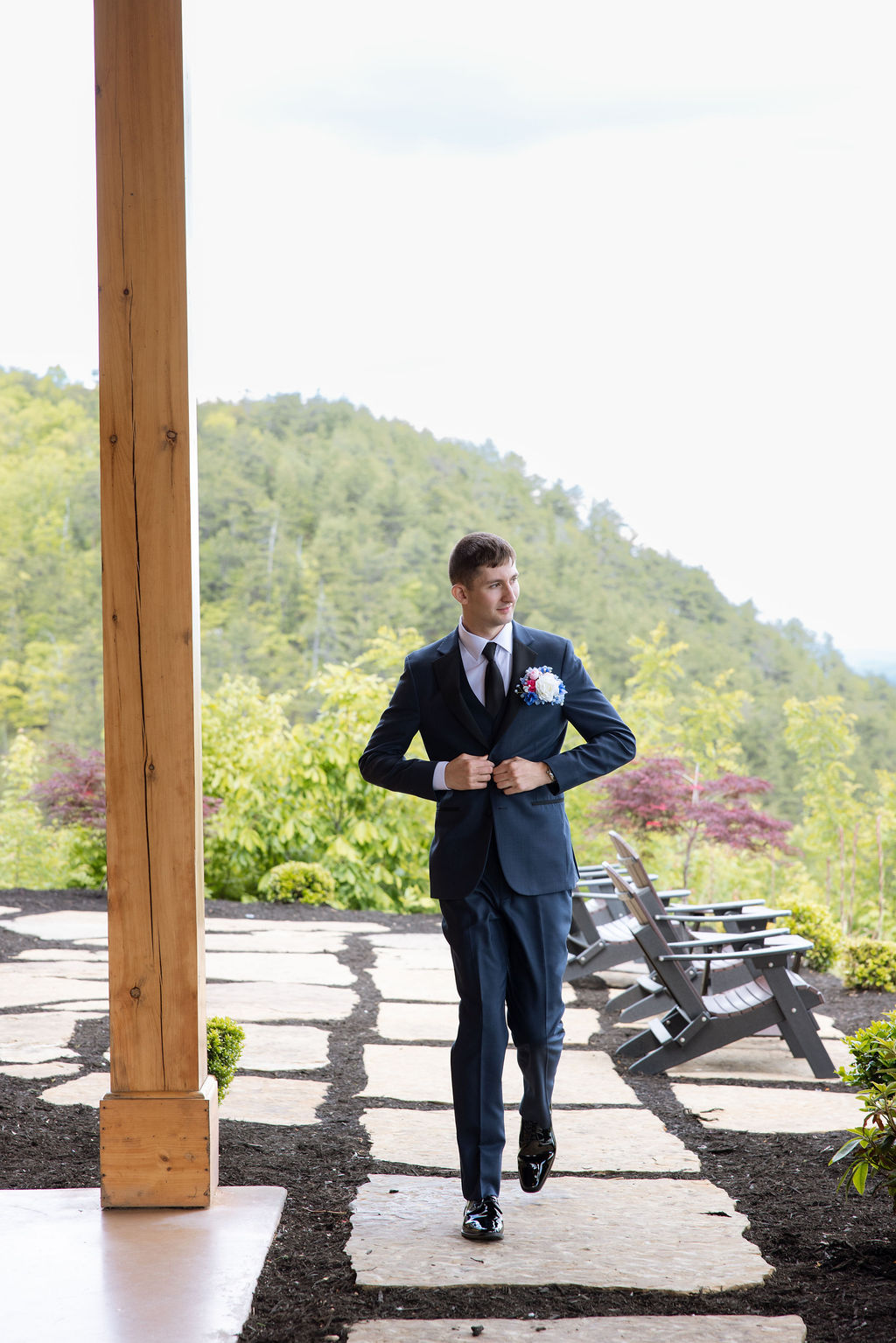 Groom portrait walking through the outdoor ceremony space at a Sevierville wedding venue