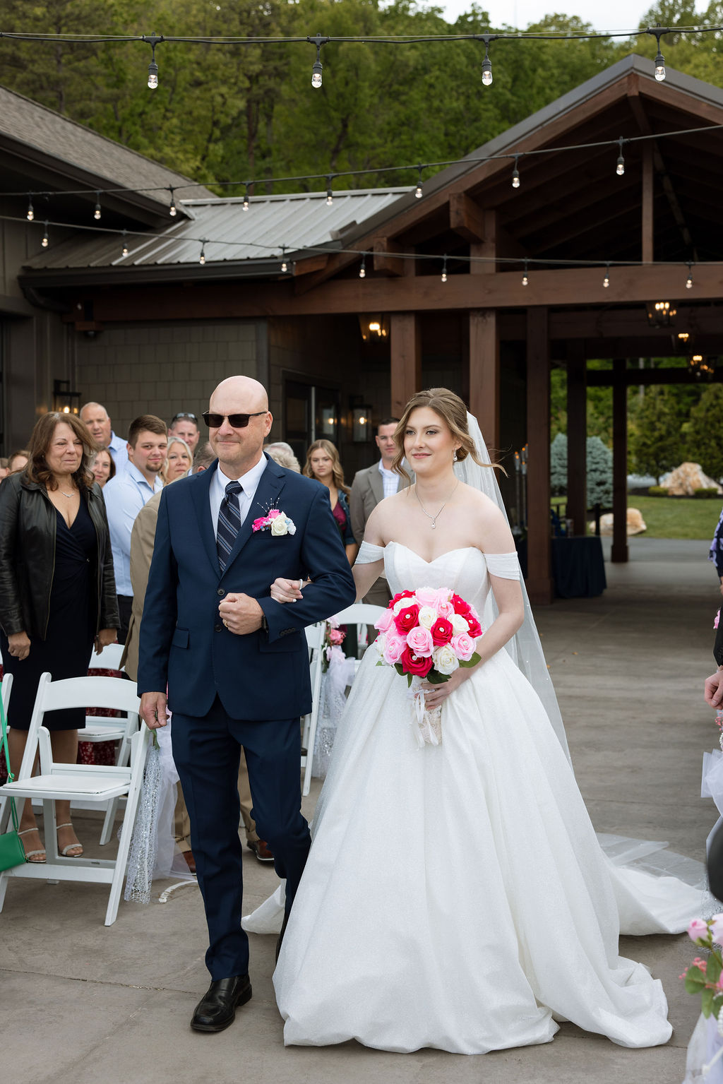 Bride walking down the aisle with her father during an outdoor mountain wedding ceremony in Tennessee
