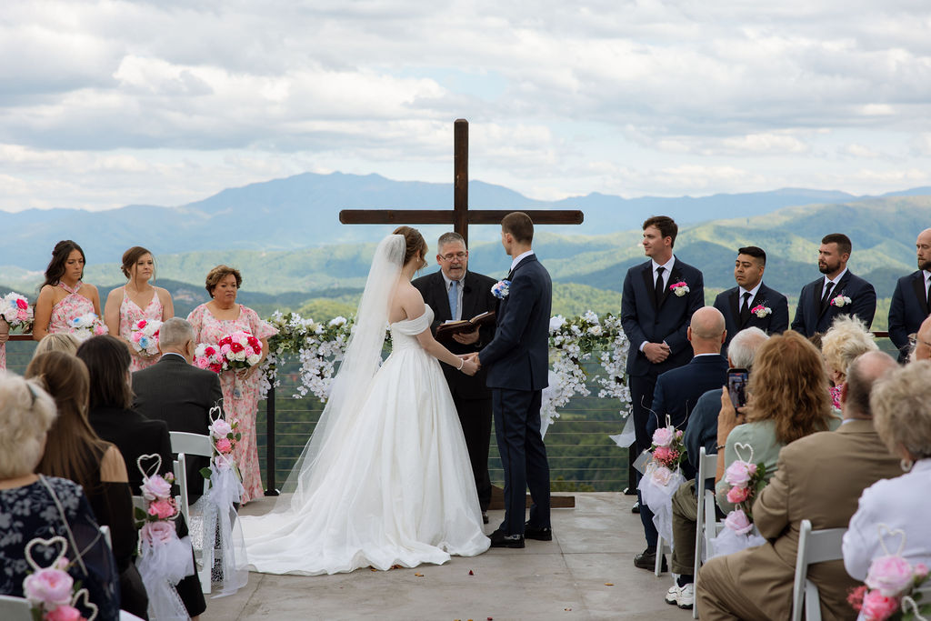 Outdoor wedding ceremony with mountain views and floral ceremony arch at a Sevierville wedding venue