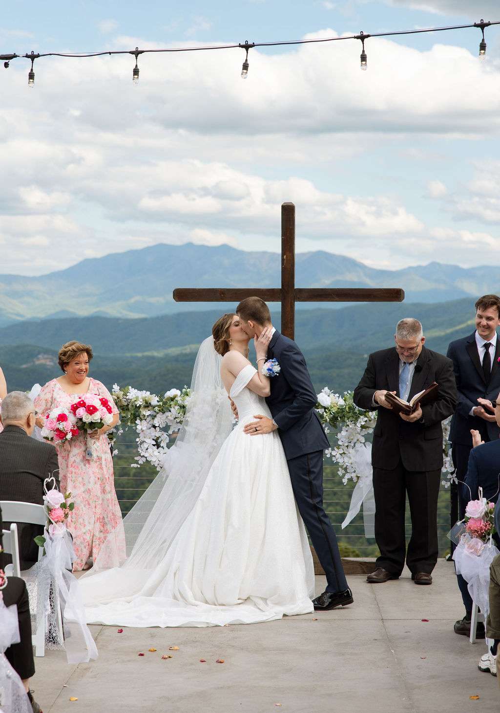 Bride and groom sharing their first kiss during an outdoor ceremony at a Sevierville wedding venue