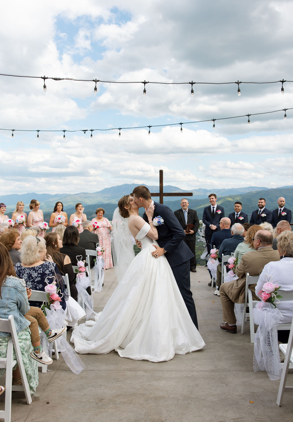 Bride and groom sharing their first kiss during an outdoor ceremony overlooking the mountains in Sevierville Tennessee