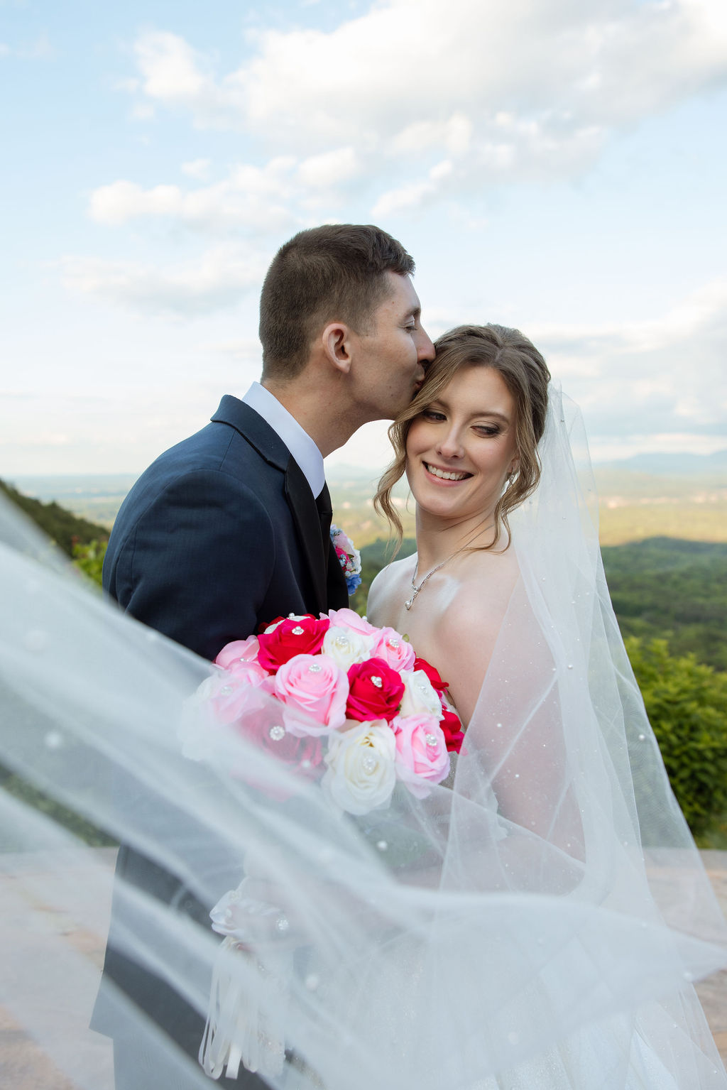 Romantic wedding portrait with flowing veil and mountain views at a Sevierville wedding venue