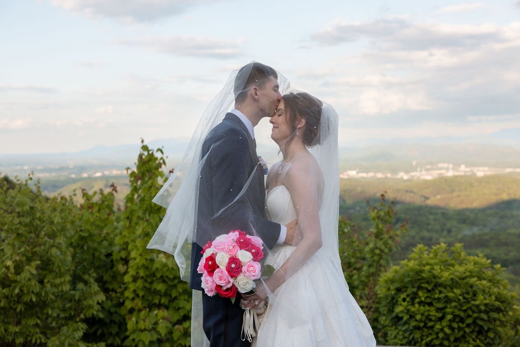 Bride and groom sharing a quiet moment with mountain views at a Sevierville wedding venue during golden hour