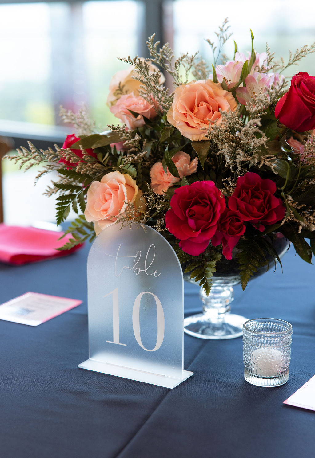 Wedding reception centerpiece with pink and red florals at a modern Sevierville wedding venue