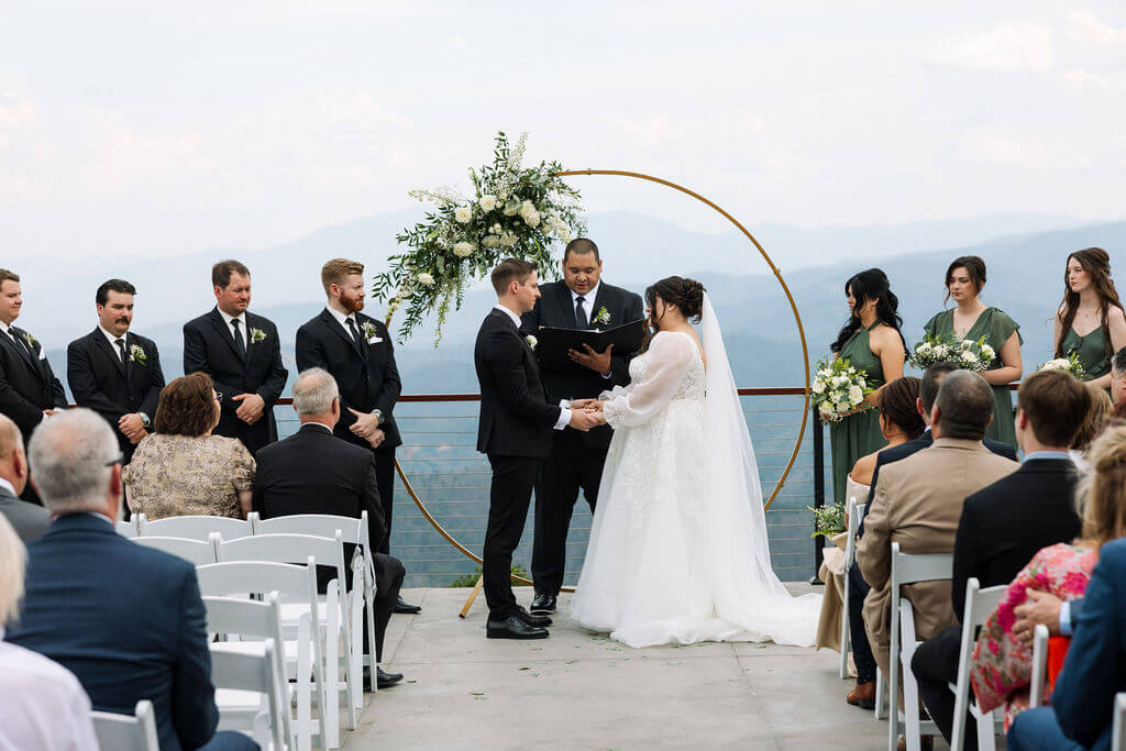 Couple exchanging vows during an outdoor ceremony overlooking the Tennessee mountains.