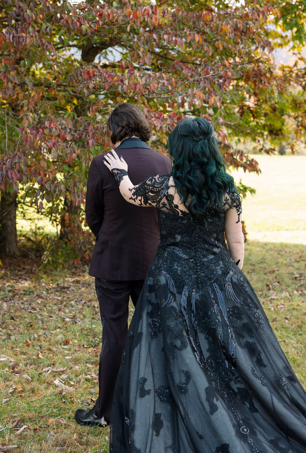 Bride tapping on her grooms shoulder during an emotional first look.
