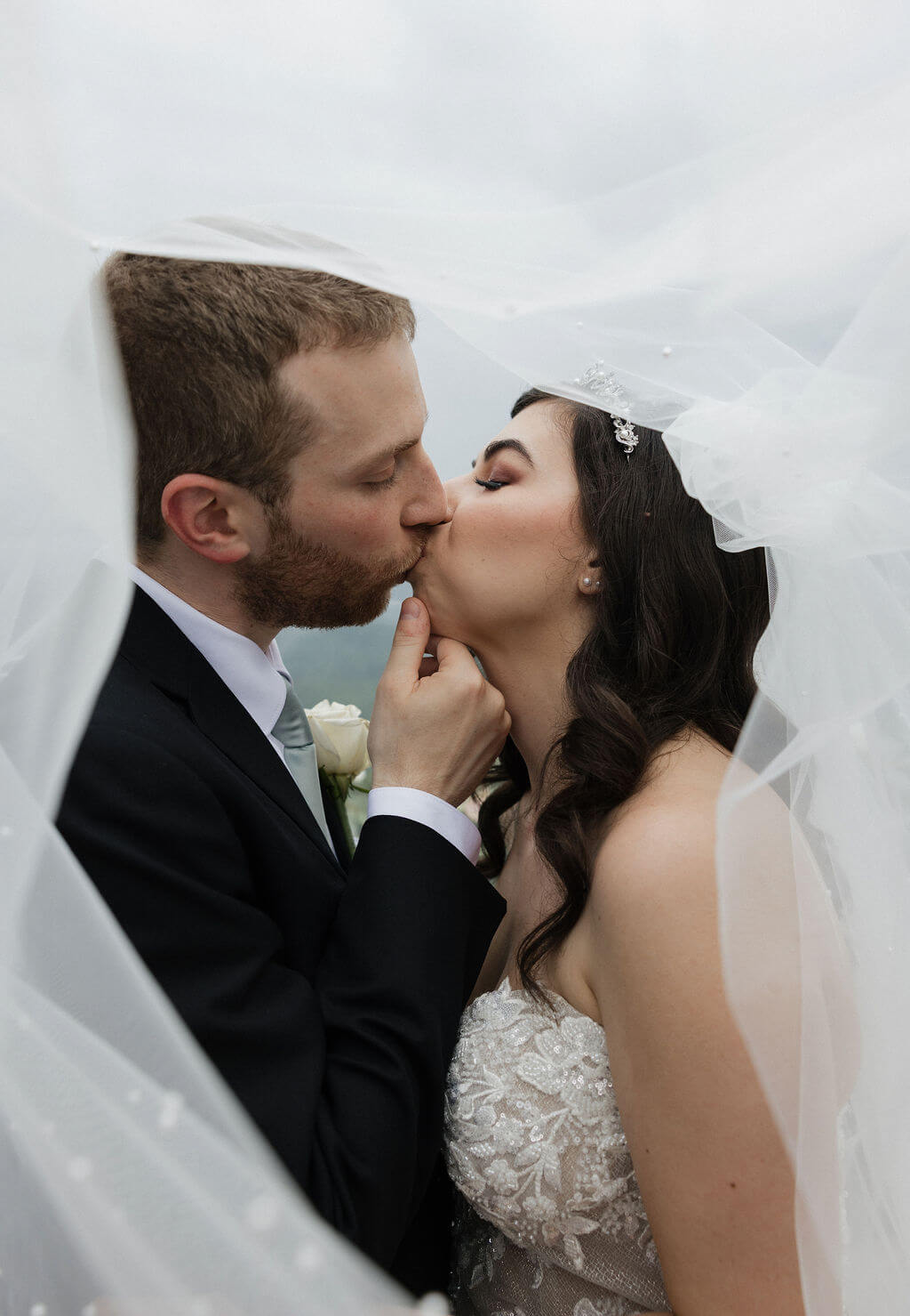 Close-up of the bride and groom kissing beneath her veil during their East Tennessee wedding portraits.