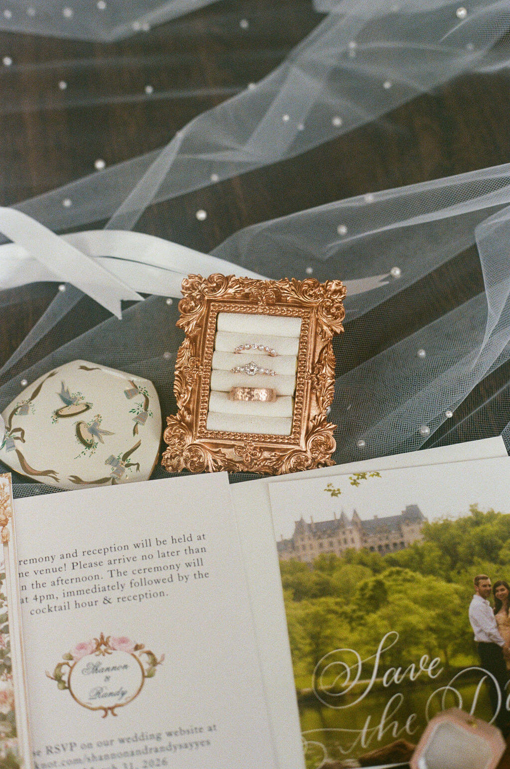 Wedding detail flat lay featuring rings, stationery, framed keepsakes, and personal details from the couple’s day.