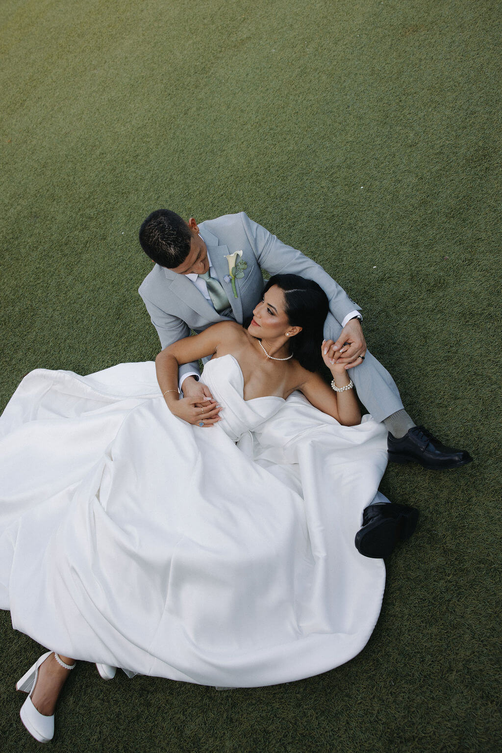Overhead portrait of a bride and groom sitting together on the lawn outside The Mill and Mine in Knoxville.