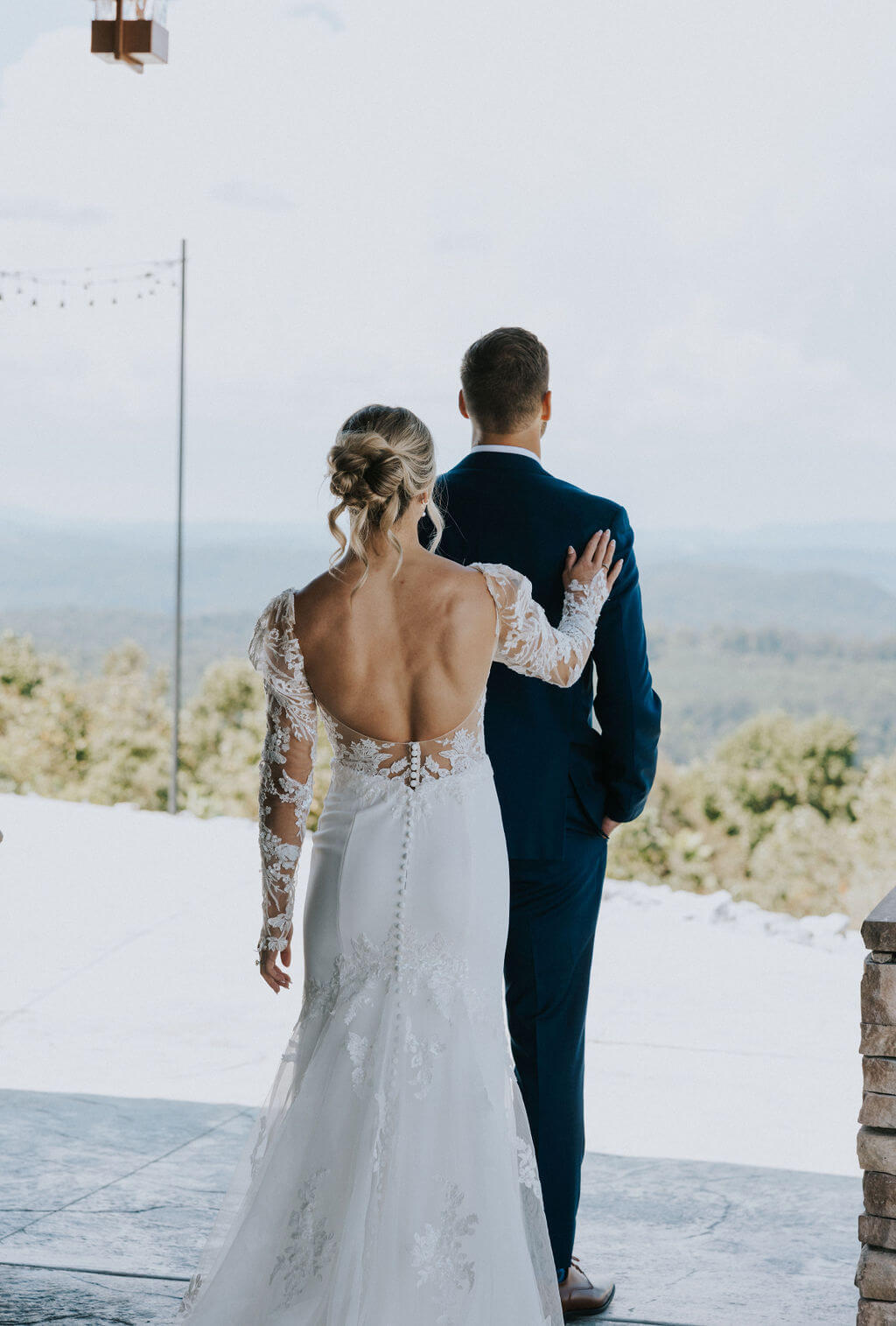 Bride approaches the groom during an outdoor first look at a mountain wedding venue.