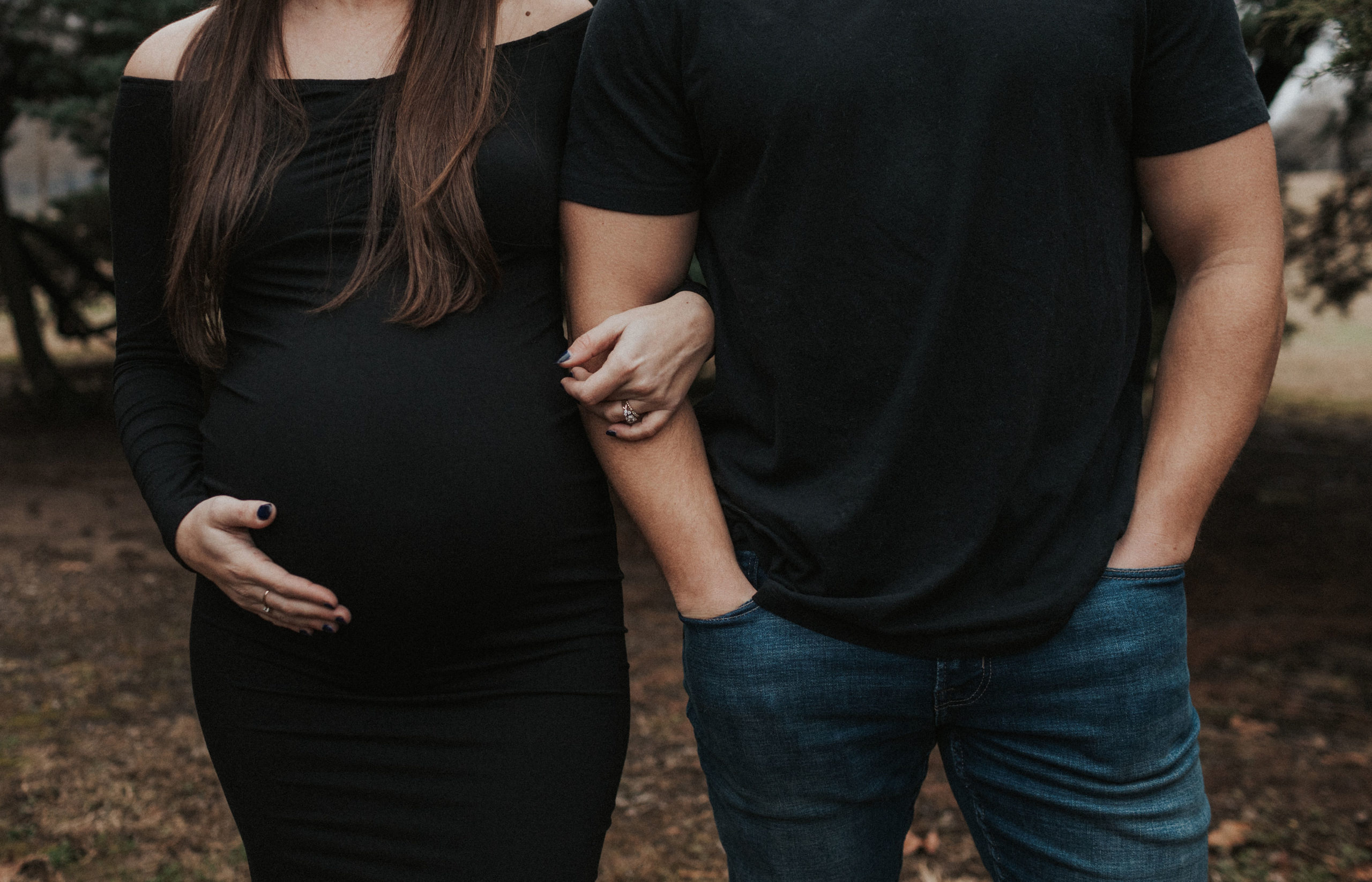 moody maternity session with couple dressed in black